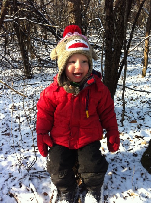 Noah was getting tired from all the walking in the woods. So, he found a stump, brushed it off and sat down. 